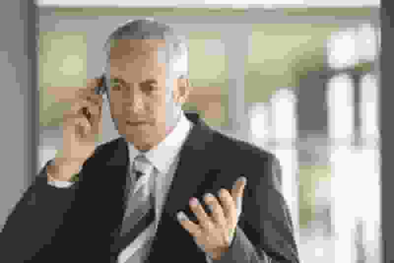 discouraged business man on cell phone