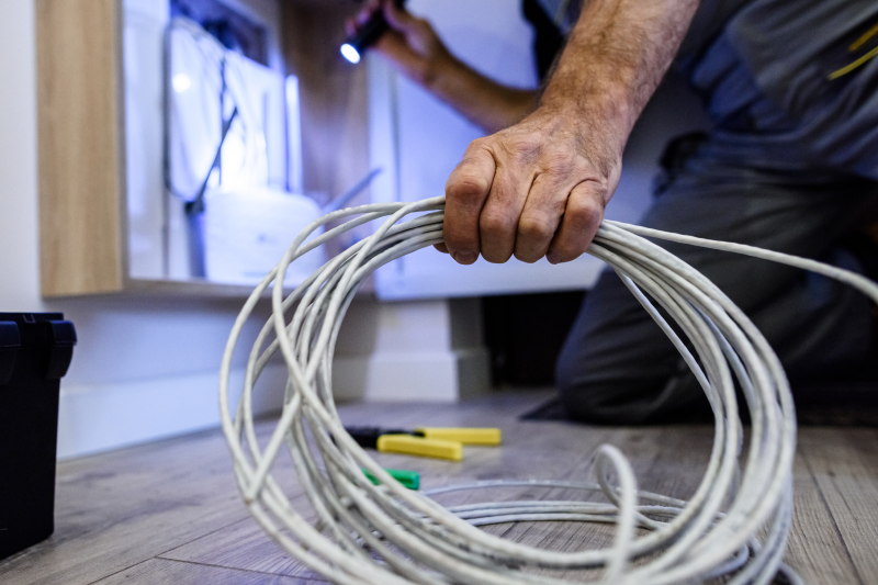 an electrician is holding power cords