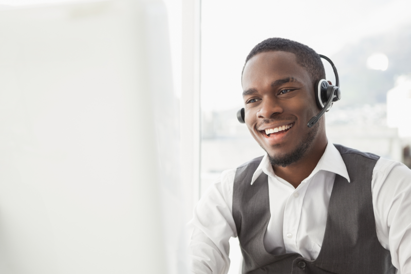 a smiling businessman talking on a headset